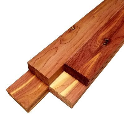Aromatic red cedar boards showing natural color variation, knots, and distinctive grain