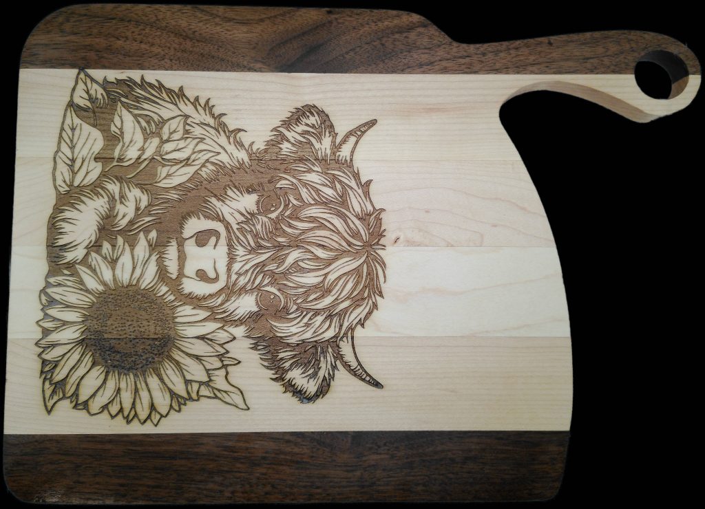 Custom thin hardwood cutting board with engraved cow design
