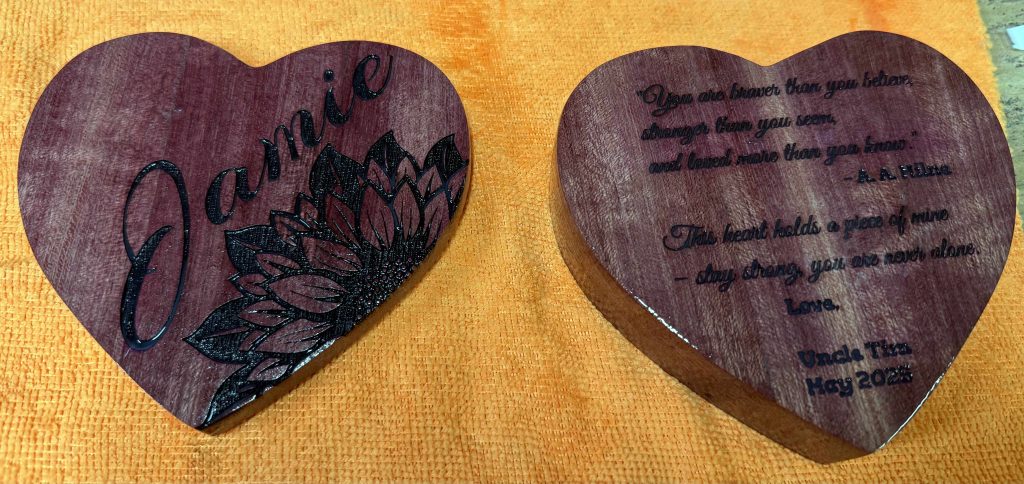 Heart-shaped purpleheart wooden trinket box with engraved design, handcrafted as a custom gift.