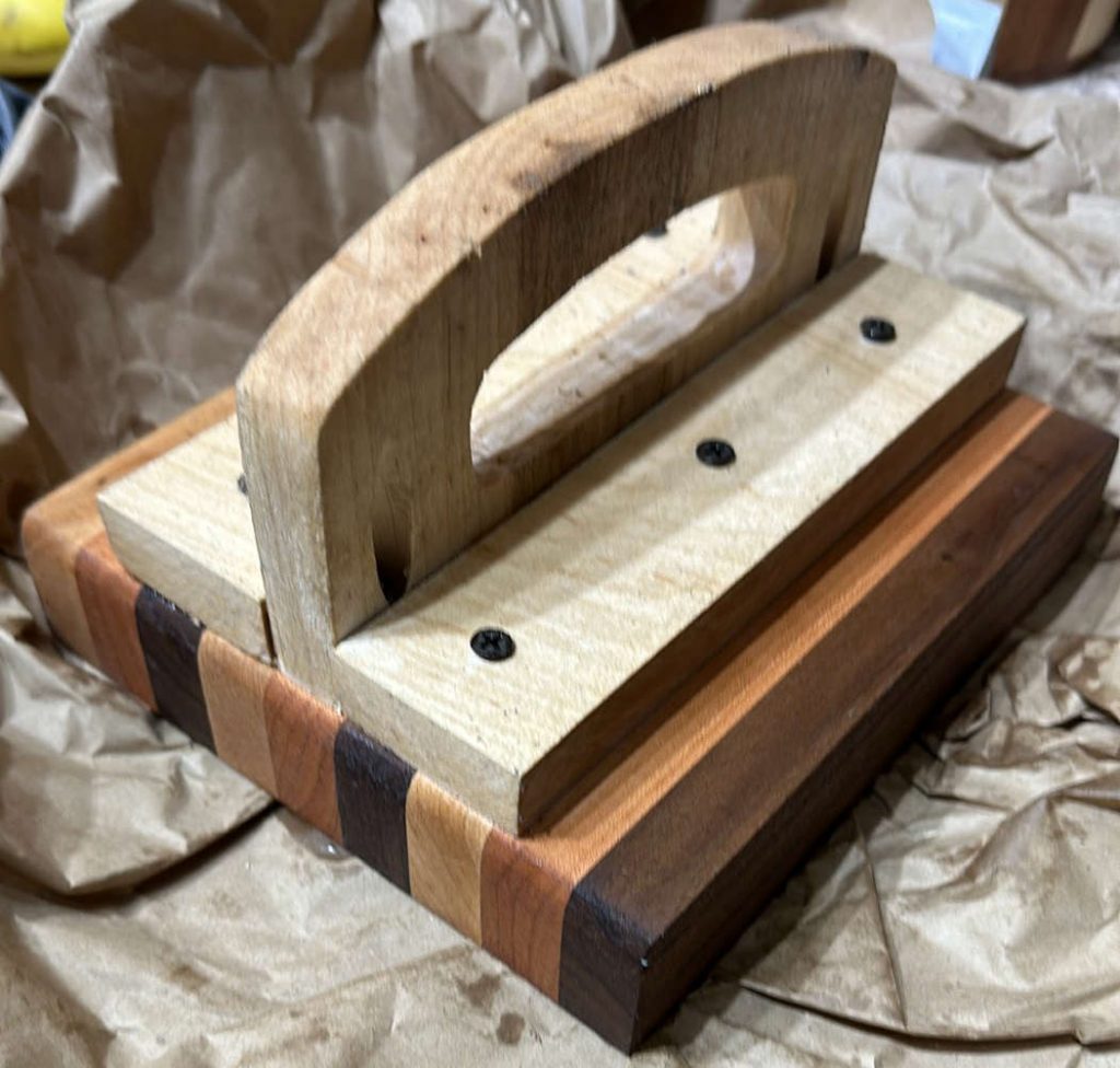 SmashMaster™ handcrafted domestic hardwood burger press with layered hardwood base and ergonomic wooden handle, custom grilling tool for smash burgers and flat-top cooking.
