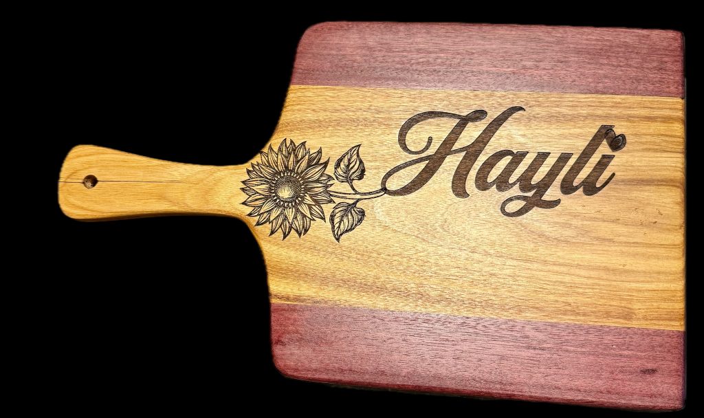 Custom hardwood cutting board with handle, laser-engraved sunflower design and personalized name, handcrafted serving and kitchen board
