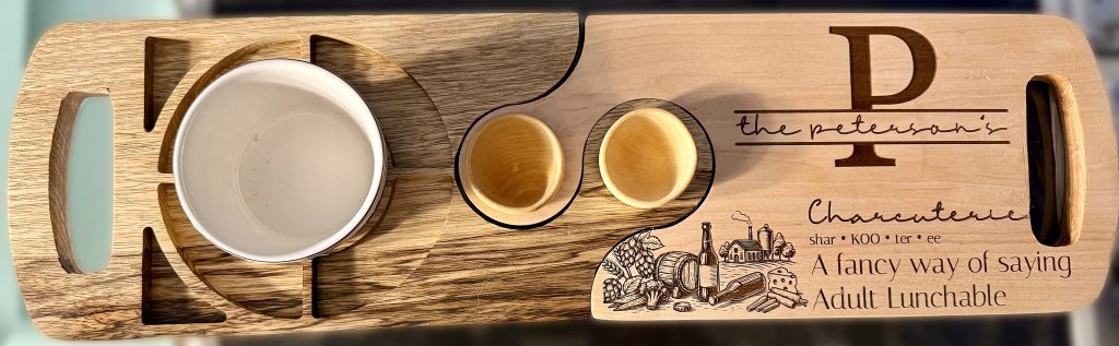 Personalized laser engraved hardwood charcuterie board with snack wells, custom monogram and artwork, handcrafted serving board.