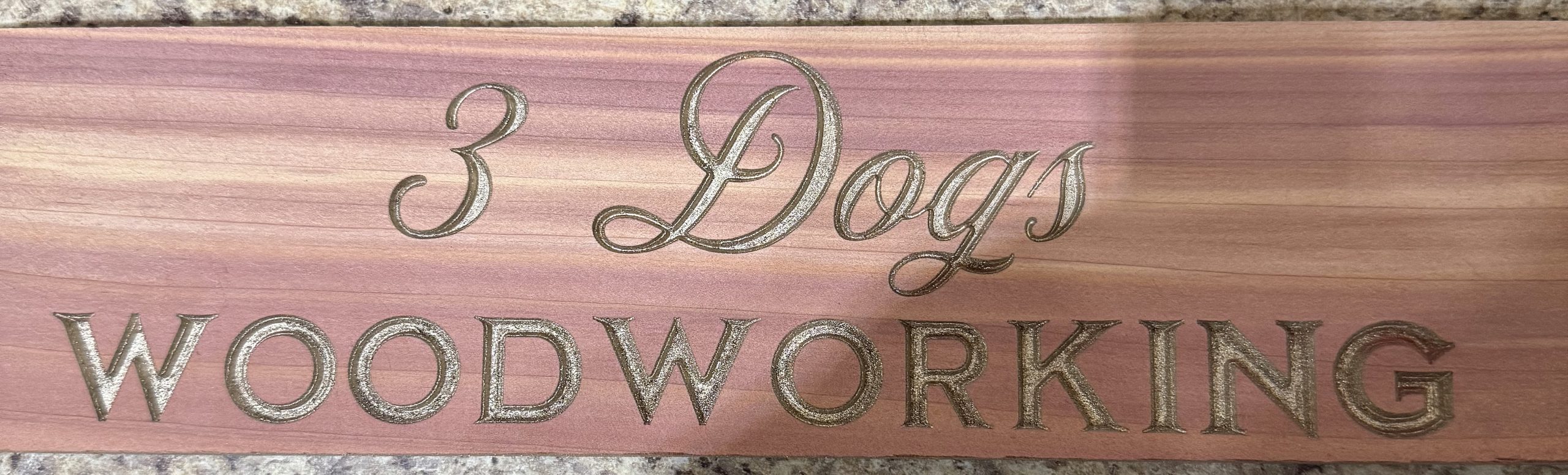 Long custom 3 Dogs Woodworking Board of Directors sign with engraved lettering and dog imagery