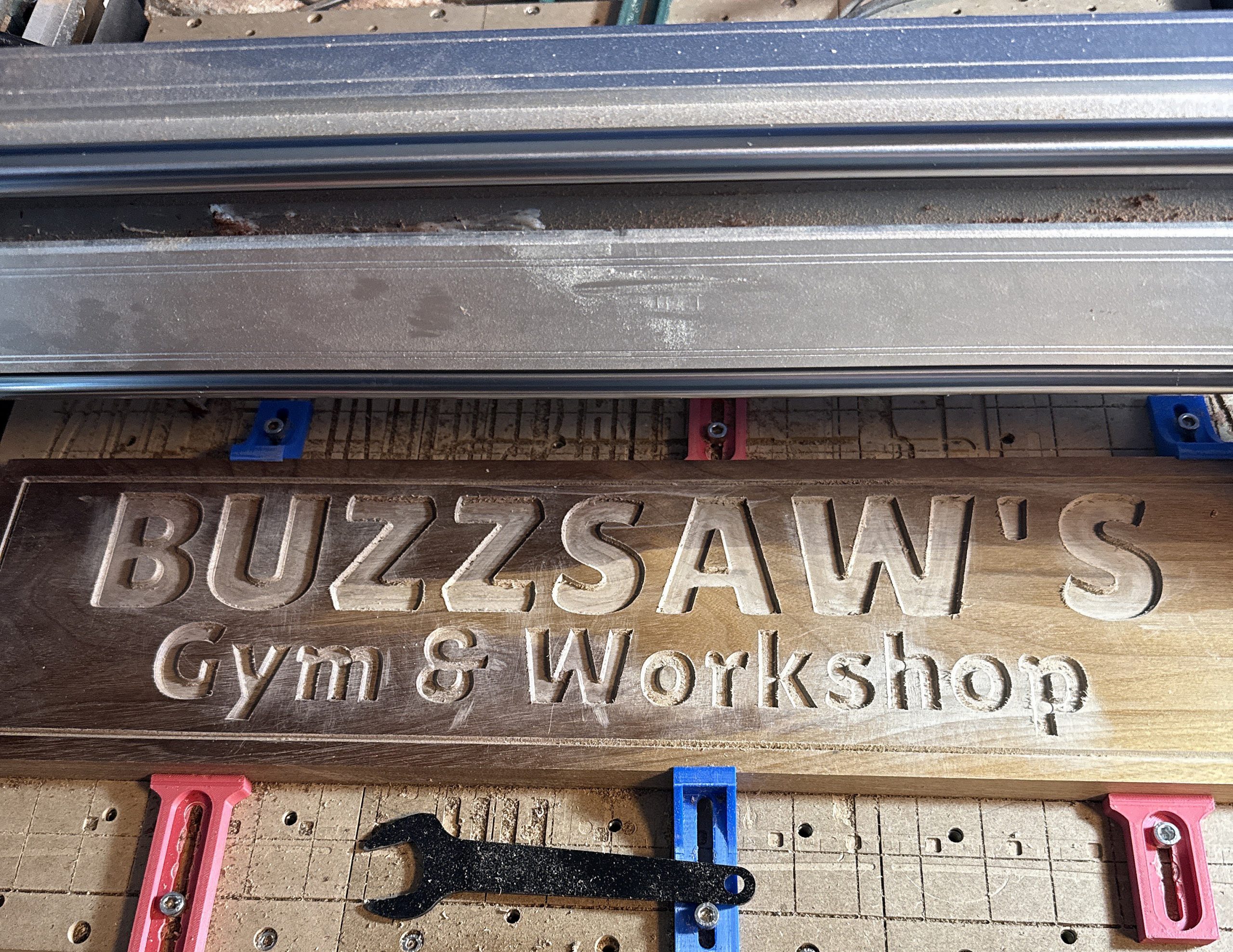 Custom wooden sign being carved on the CNC during the 3 Dogs Woodworking production process